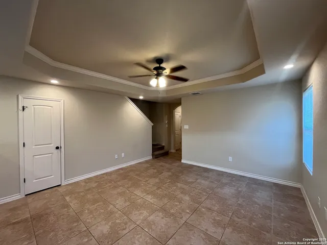 a view of an empty room with a ceiling fan