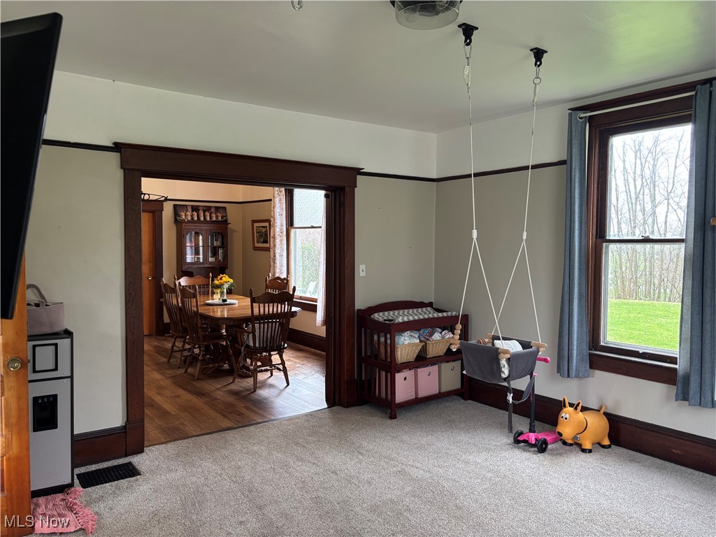 6380 Old River Road Philo, OH 43771 - Photo 18 of 26 Carpeted bedroom with visible vents and multiple windows