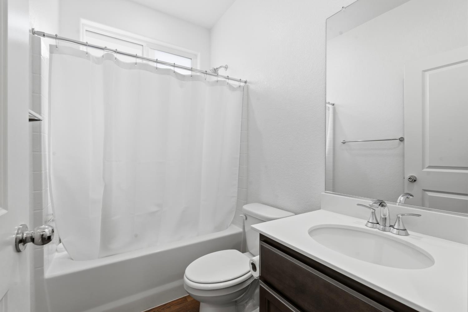 5713 Natalie Way Keyes, CA 95328 - Photo 21 of 30 a bathroom with a granite countertop sink toilet a mirror and shower