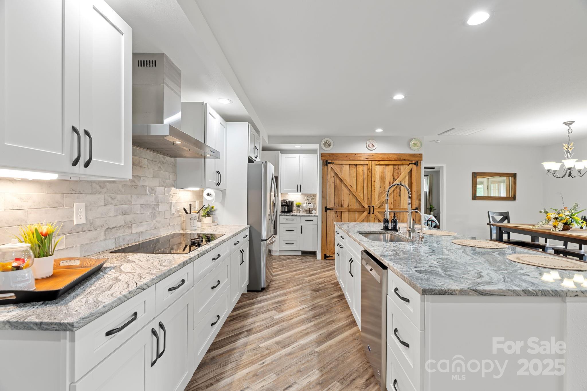 204 Mountain Spring Lane Canton, NC 28716 - Photo 13 of 45 a large kitchen with granite countertop a sink and cabinets