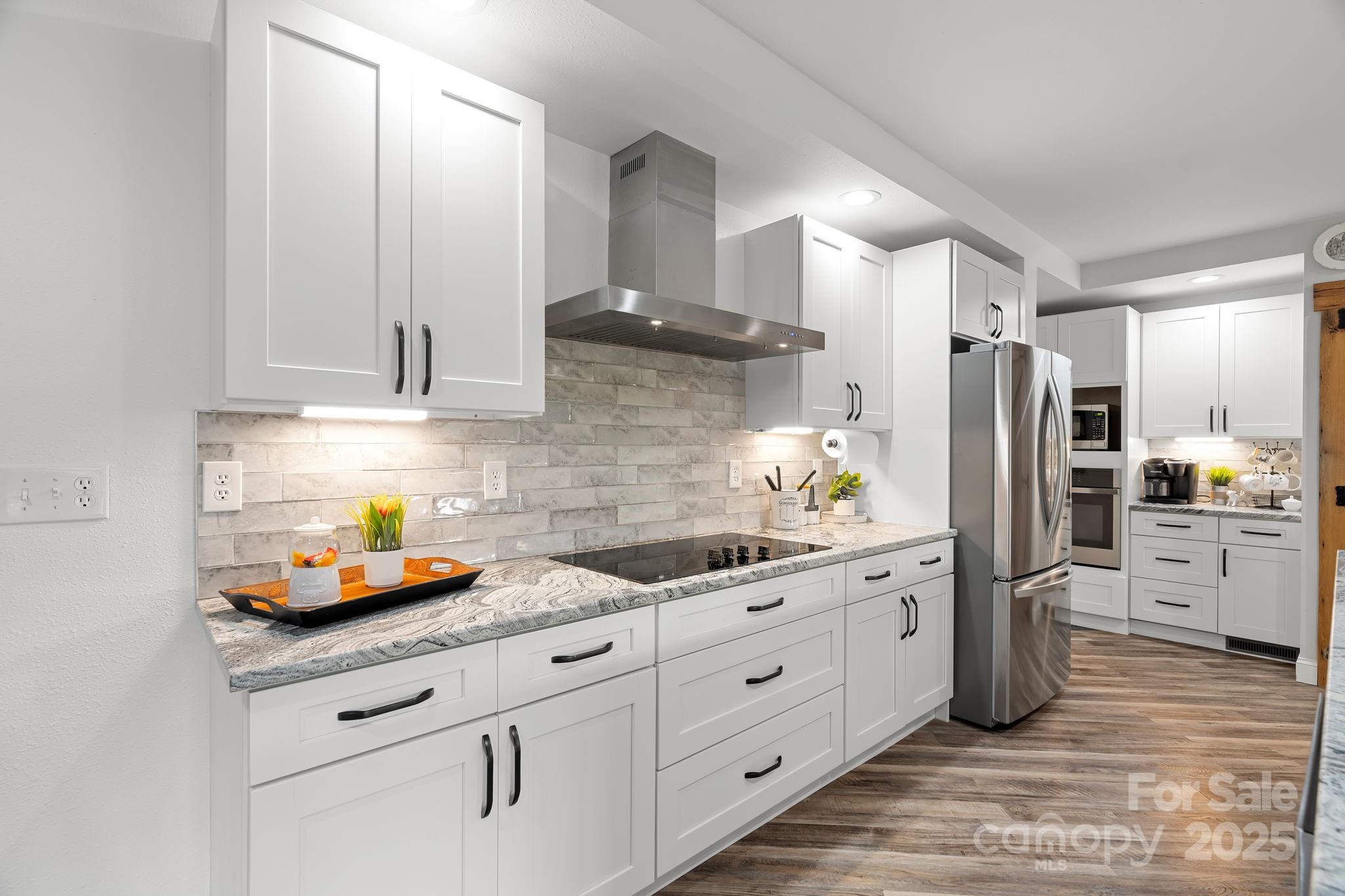 204 Mountain Spring Lane Canton, NC 28716 - Photo 14 of 45 a kitchen with white cabinets and stainless steel appliances