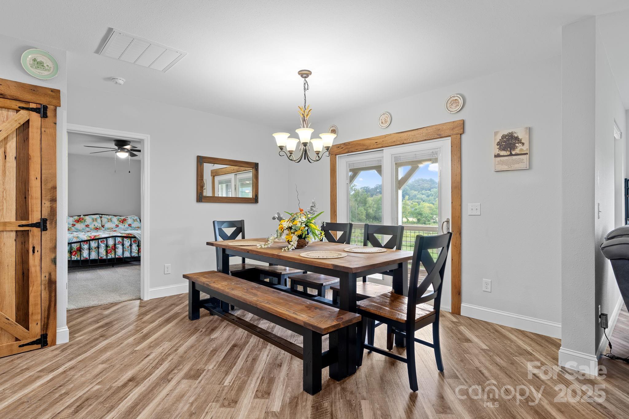 204 Mountain Spring Lane Canton, NC 28716 - Photo 19 of 45 a dining room with furniture a rug and a chandelier