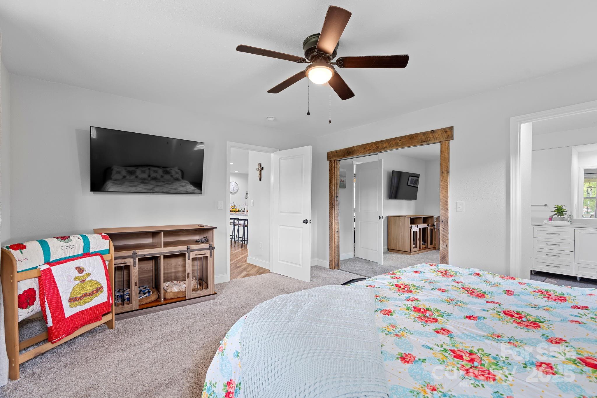 204 Mountain Spring Lane Canton, NC 28716 - Photo 24 of 45 a bedroom with a bed and a flat screen tv