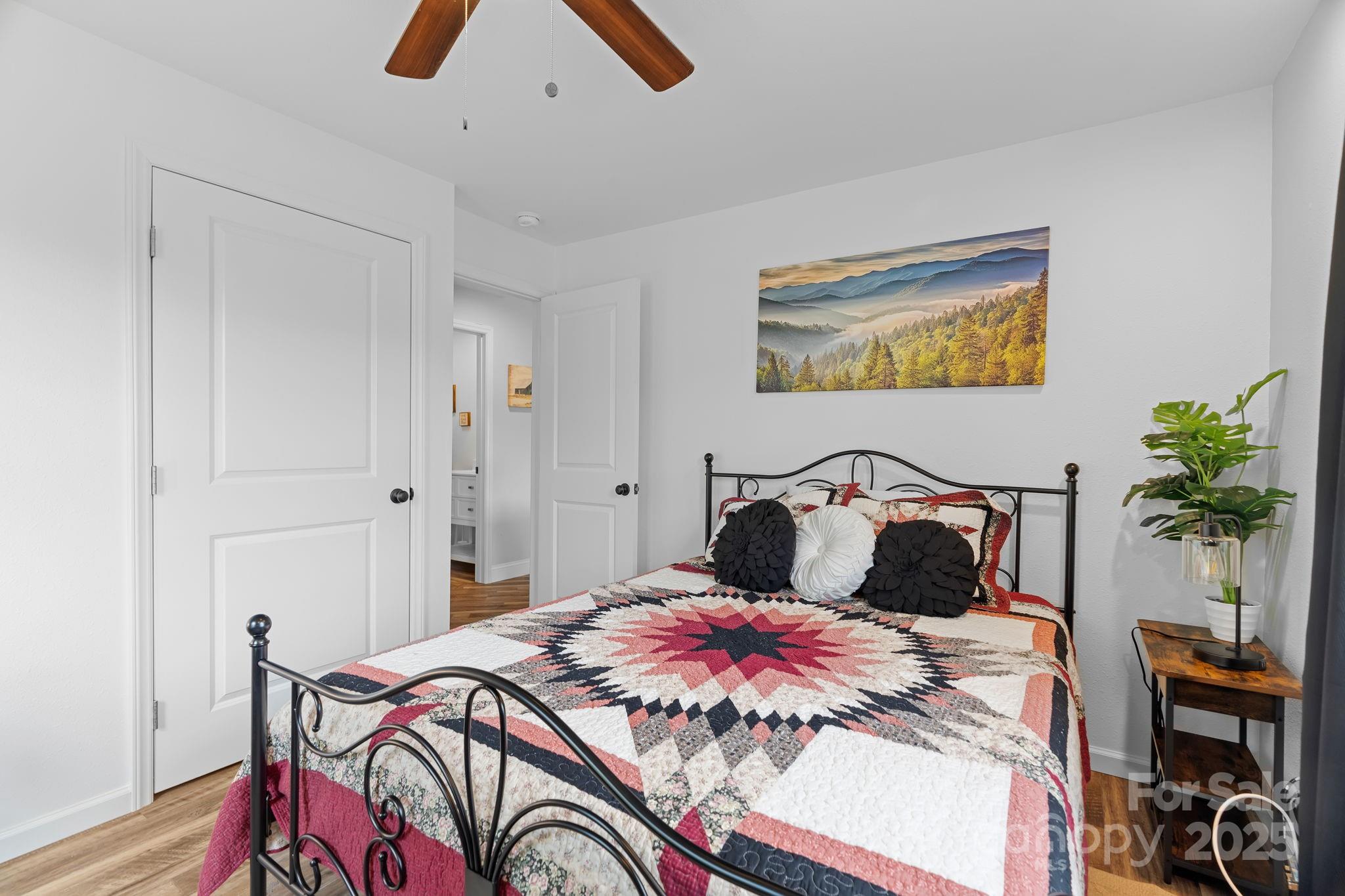 204 Mountain Spring Lane Canton, NC 28716 - Photo 28 of 45 a bedroom with a bed and a chandelier