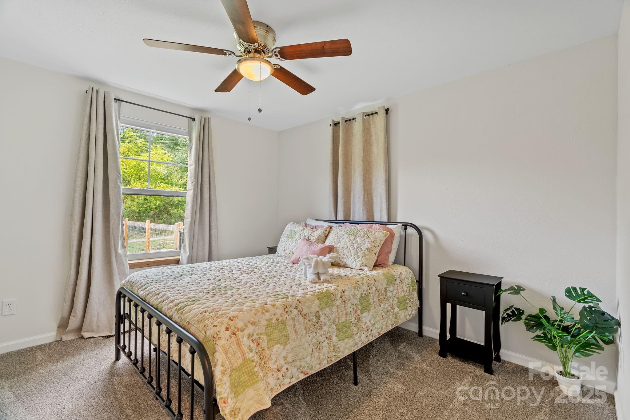 204 Mountain Spring Lane Canton, NC 28716 - Photo 30 of 45 a bedroom with a bed and a window