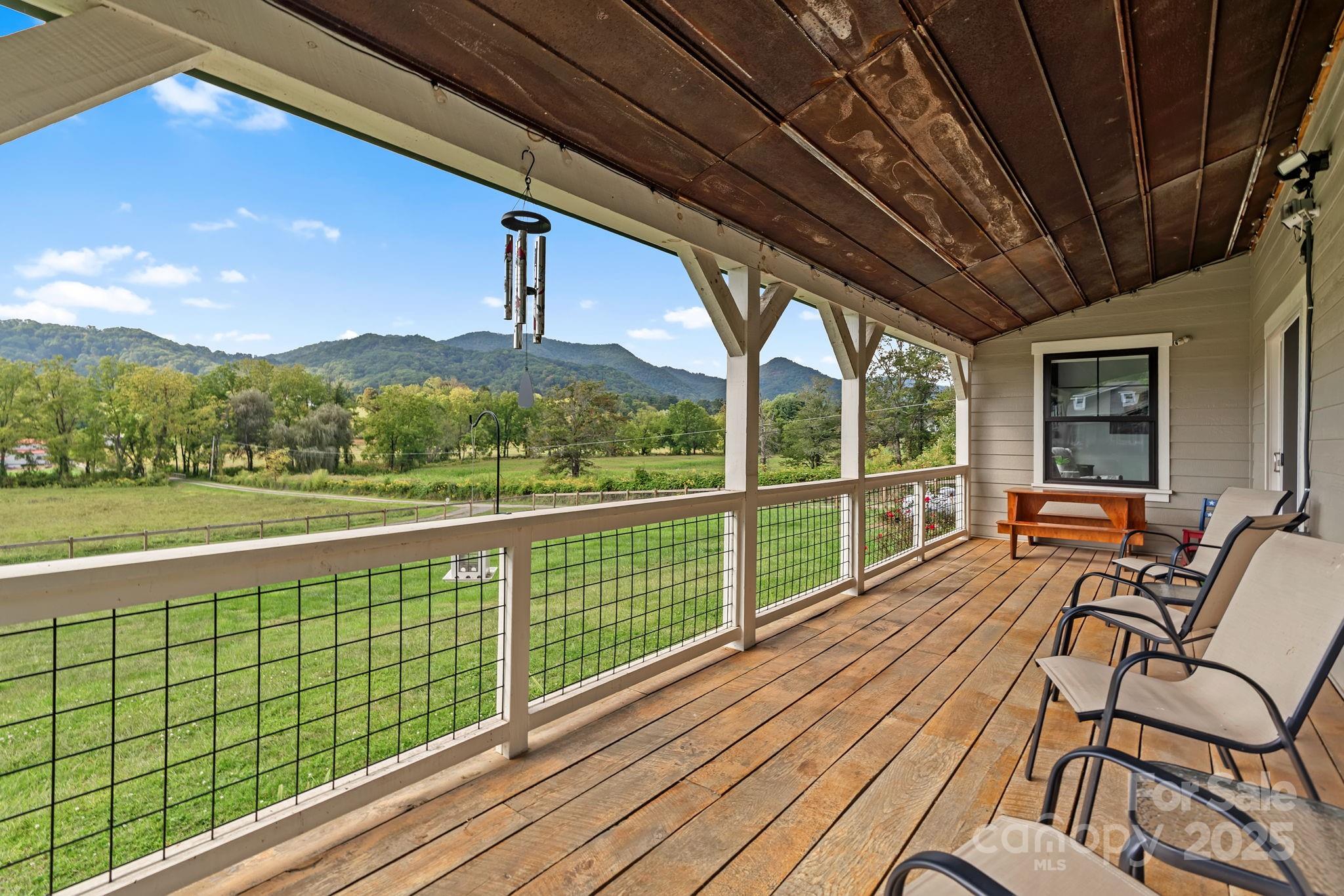 204 Mountain Spring Lane Canton, NC 28716 - Photo 3 of 45 a balcony with wooden floor and outdoor seating