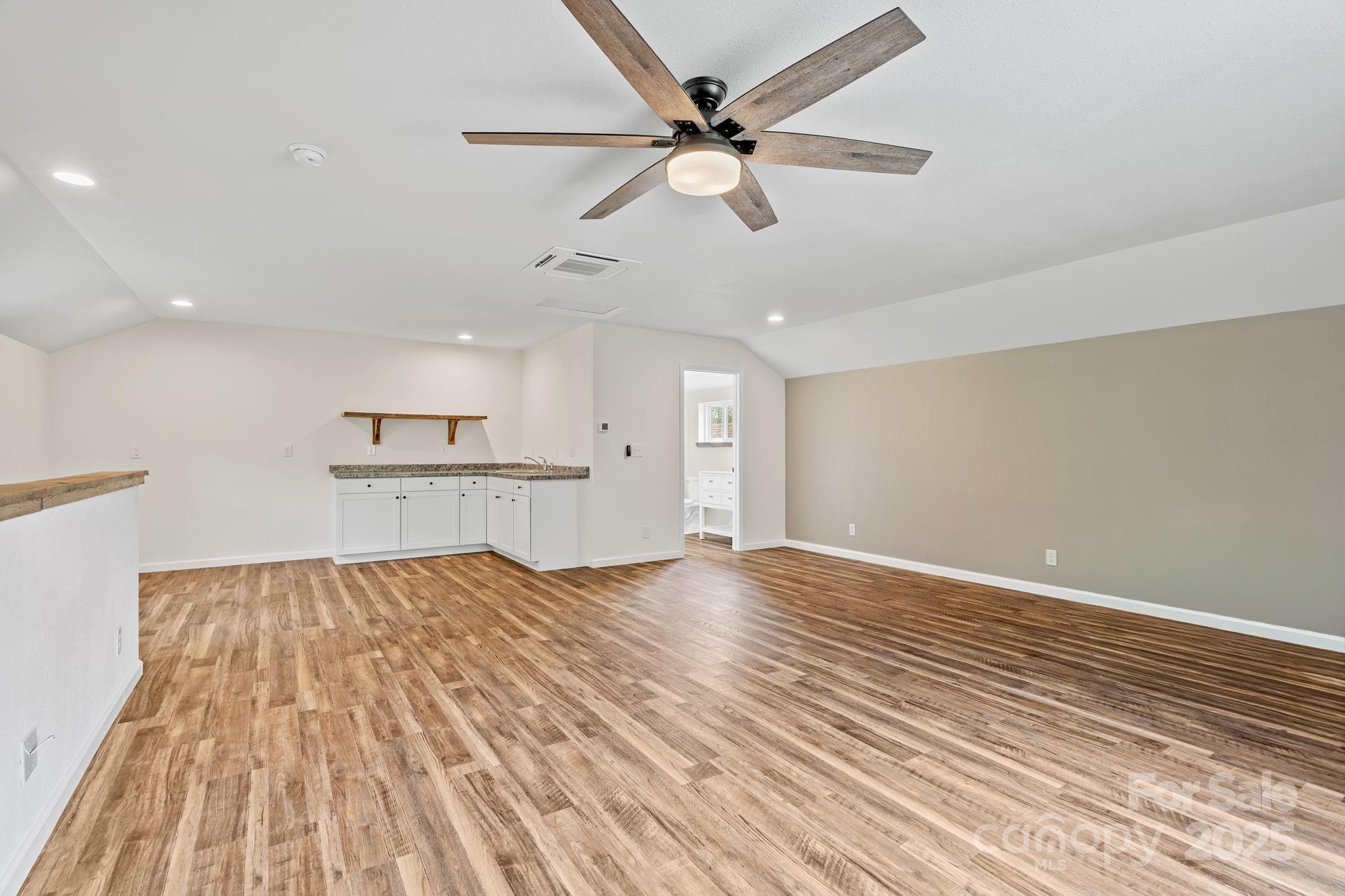 204 Mountain Spring Lane Canton, NC 28716 - Photo 35 of 45 a view of empty room with wooden floor and ceiling fan