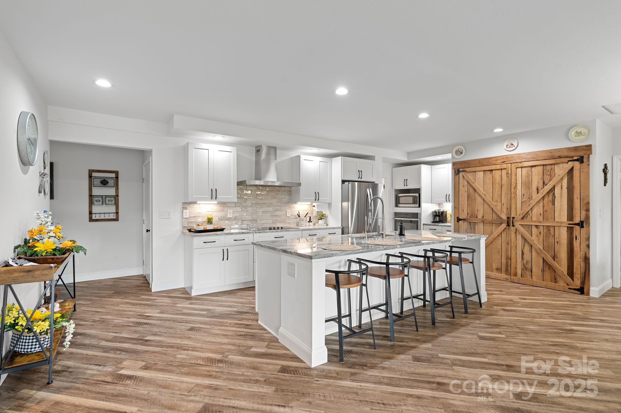 204 Mountain Spring Lane Canton, NC 28716 - Photo 4 of 45 a kitchen with stainless steel appliances granite countertop a table chairs sink refrigerator and microwave
