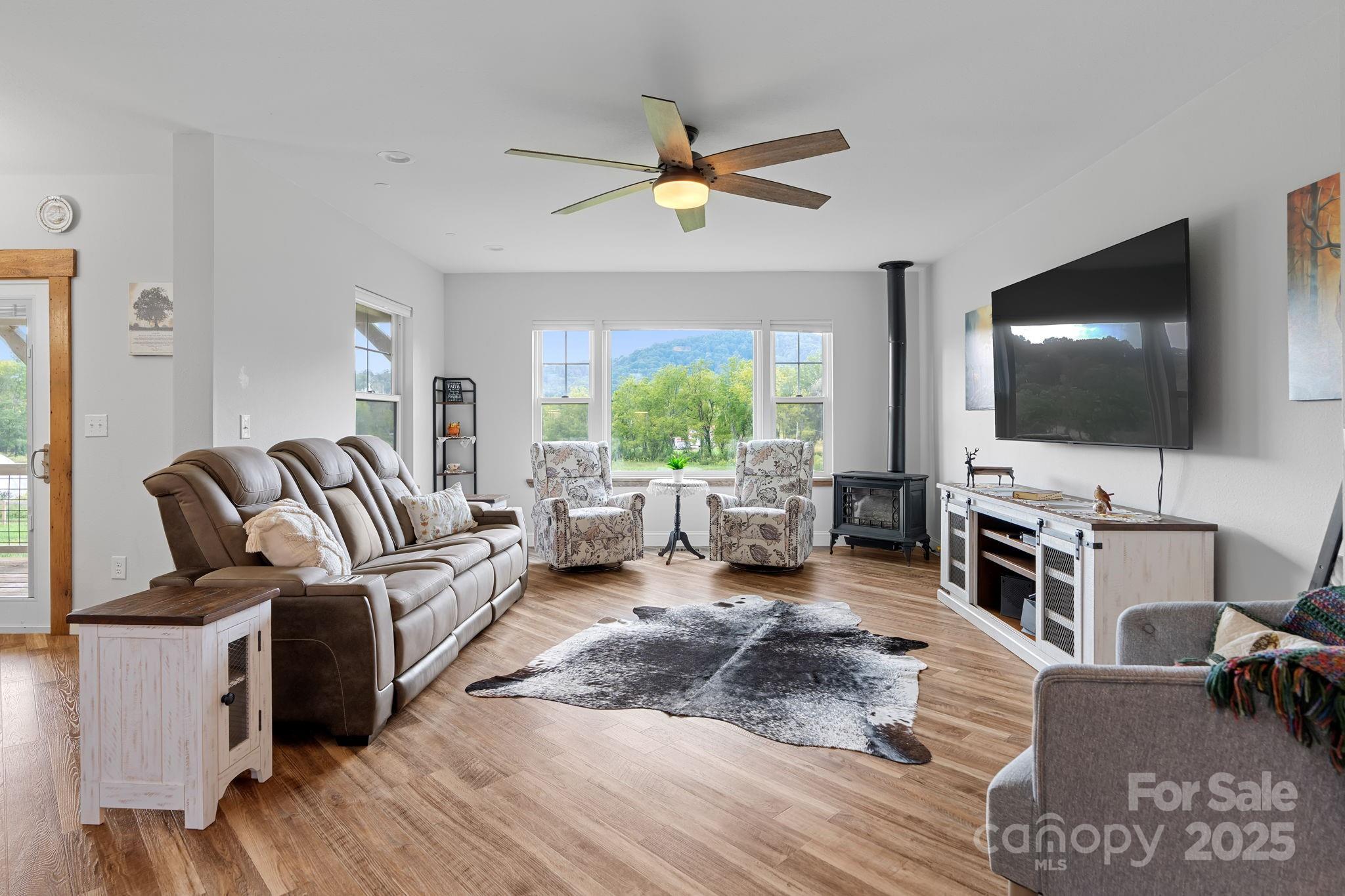 204 Mountain Spring Lane Canton, NC 28716 - Photo 9 of 45 a living room with furniture and a flat screen tv