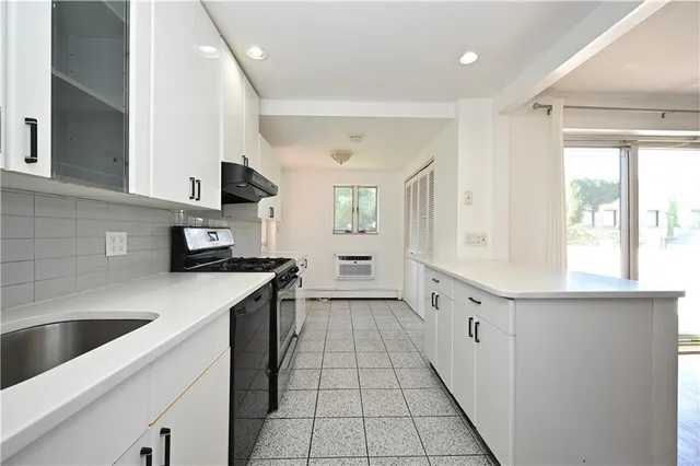 a kitchen with stainless steel appliances granite countertop a sink and a stove