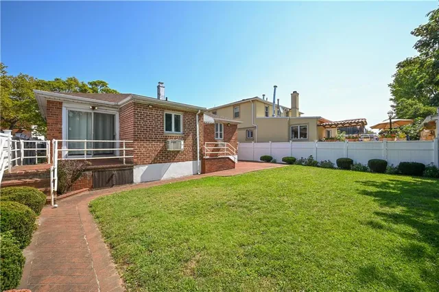a view of a house with a backyard and a garden