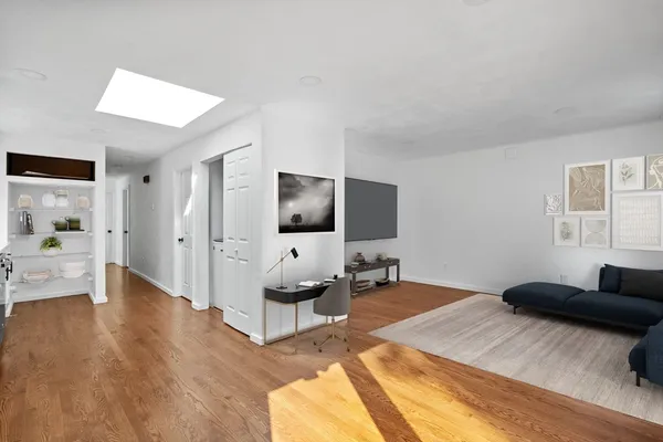 a bedroom with furniture and a flat screen tv