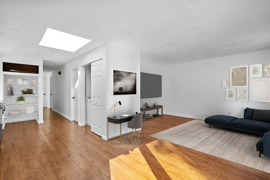 a bedroom with furniture and a flat screen tv