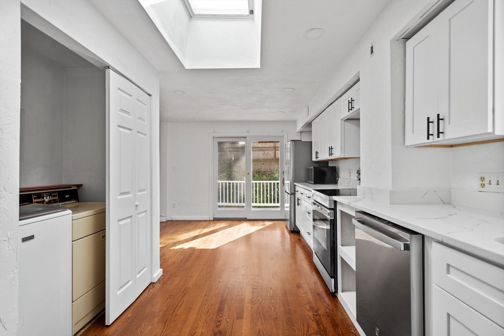 61 Wordsworth Street, Unit 2 Boston, MA 02128 - Photo 3 of 12 a kitchen with a stove a sink and a refrigerator