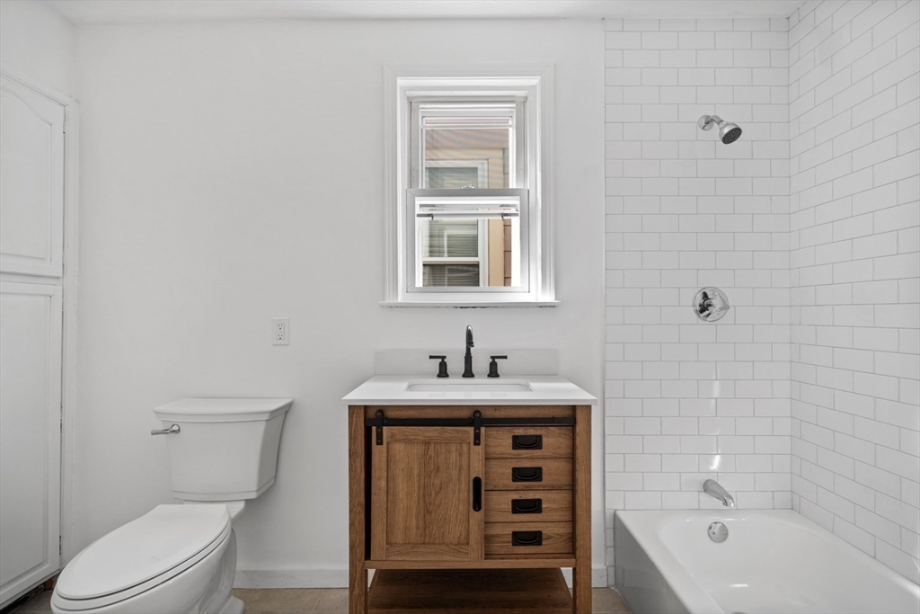 61 Wordsworth Street, Unit 2 Boston, MA 02128 - Photo 8 of 12 a bathroom with a sink a toilet and bathtub