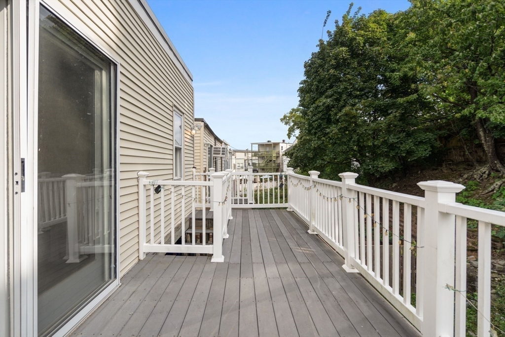 61 Wordsworth Street, Unit 2 Boston, MA 02128 - Photo 10 of 12 a view of a wooden deck with a yard