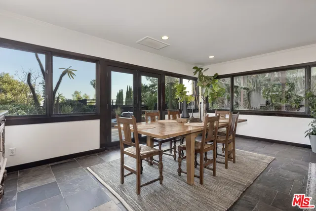 a dining room with furniture a chandelier and wooden floor