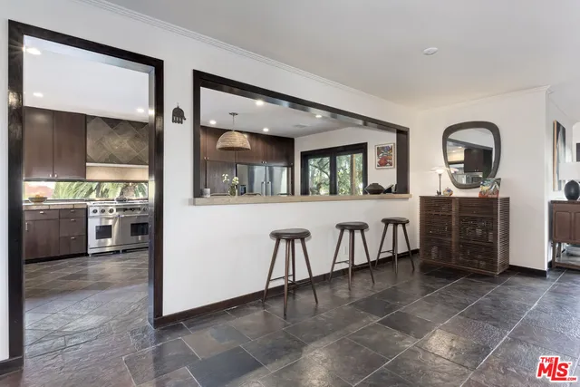 a view of a living room kitchen and entryway