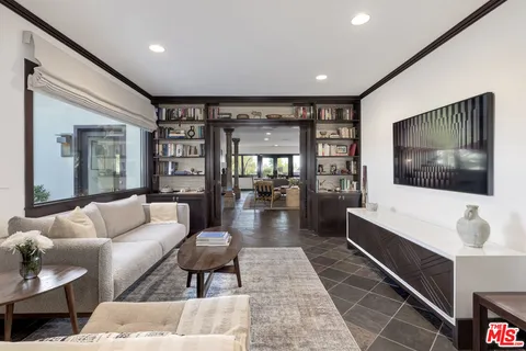 a bedroom with a bed next to a window