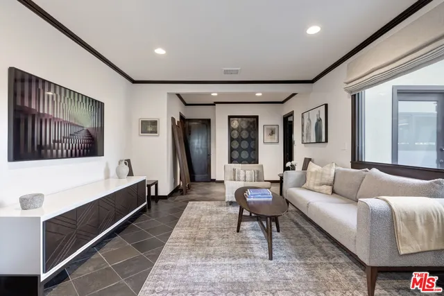 a living room with furniture and a rug