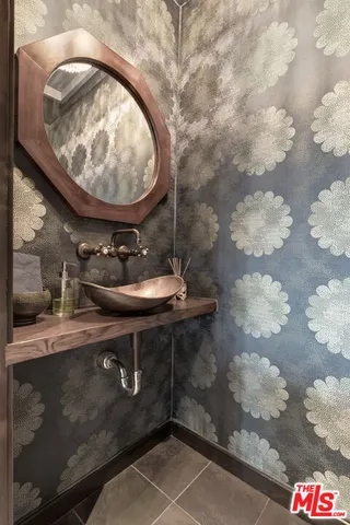 a room with water heater and racks on side of a counter