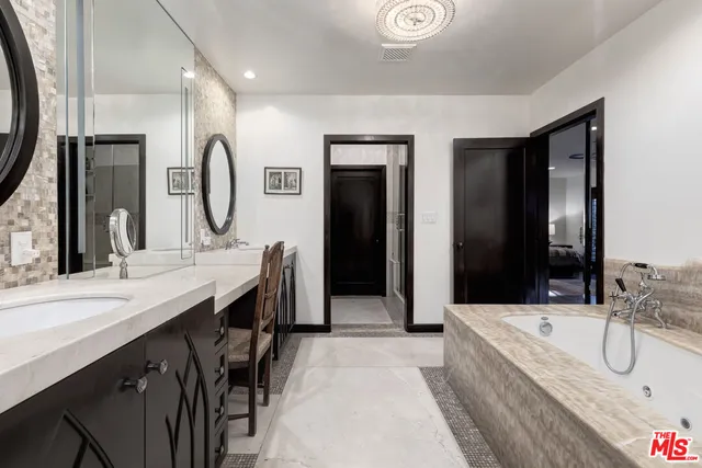 a bathroom with double vanity sink and a mirror