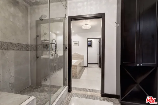 a bathroom with a glass shower door