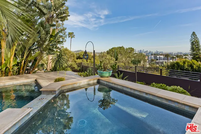a outdoor living space with furniture potted plant and a large window