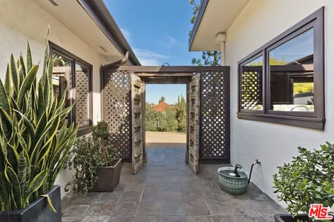a living room with fireplace furniture and a large window
