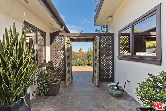a living room with fireplace furniture and a large window