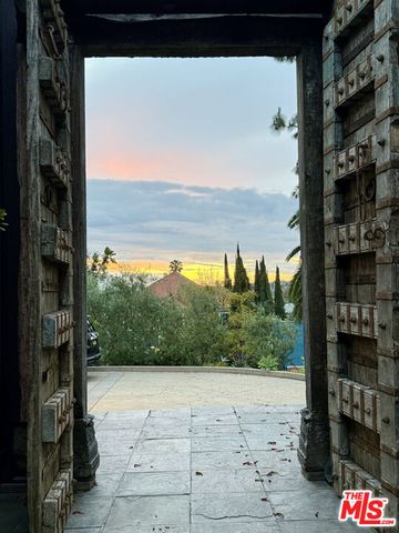 a living room with furniture a fireplace and a floor to ceiling window