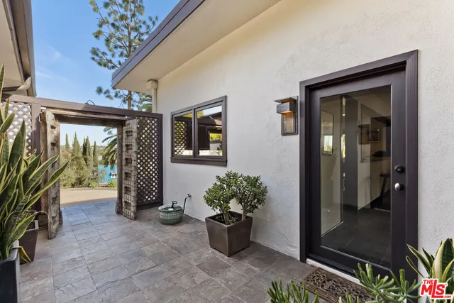 a view of an entryway door and deck in the room