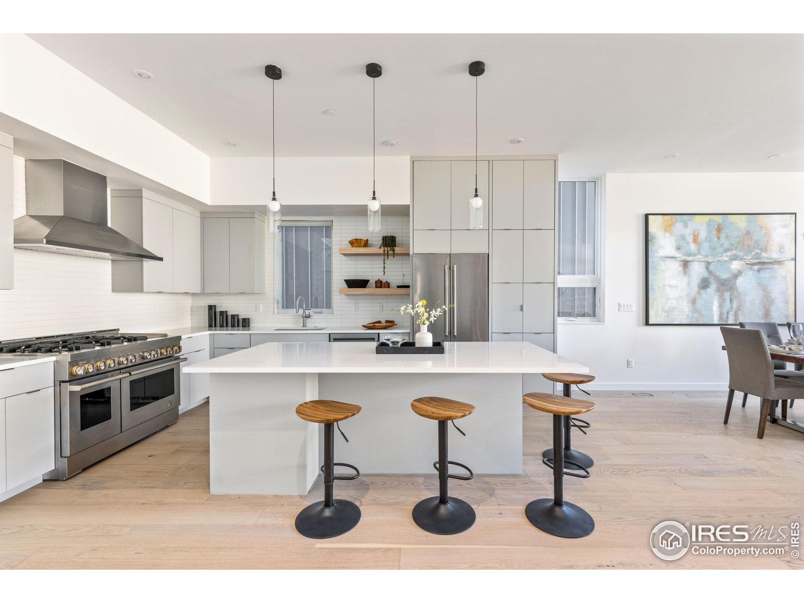 3315 Broadway Boulder, CO 80304 - Photo 2 of 42 a kitchen with a sink a stove and chairs