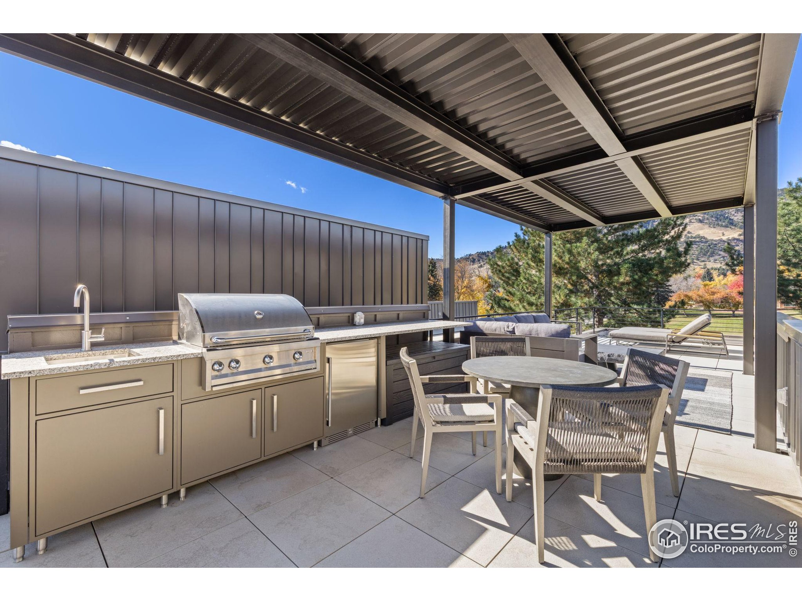 3315 Broadway Boulder, CO 80304 - Photo 40 of 42 a kitchen with a table chairs and a grill