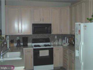 5 Sandstone Road Hightstown, NJ 08520 - Photo 3 of 5 a kitchen with stainless steel appliances granite countertop a stove a microwave and a refrigerator
