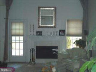 5 Sandstone Road Hightstown, NJ 08520 - Photo 4 of 5 a living room with a fireplace and a window