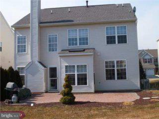 5 Sandstone Road Hightstown, NJ 08520 - Photo 5 of 5 a front view of a house with a yard and garage