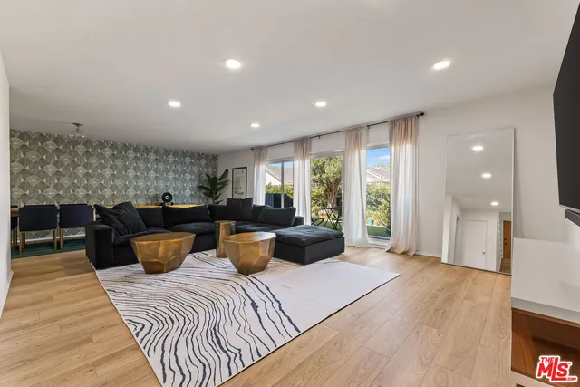 a living room with furniture a window and a table