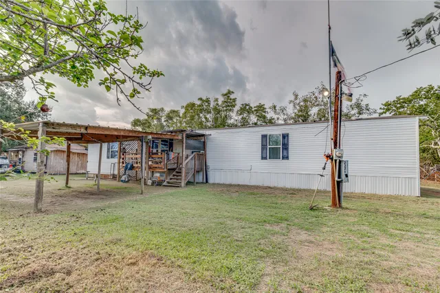 a view of a house with backyard porch and sitting area