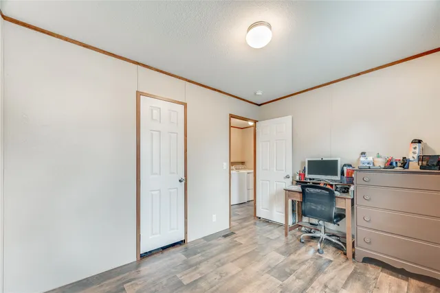 a view of a workspace with furniture and a window