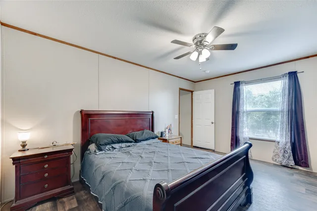 a bed sitting in a bedroom next to a window