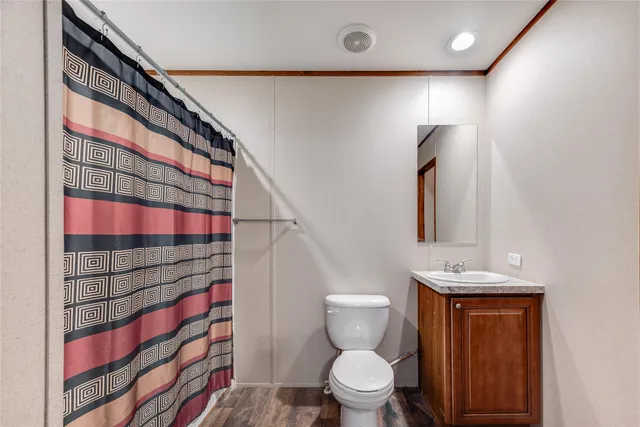 a bathroom with a toilet sink and shower