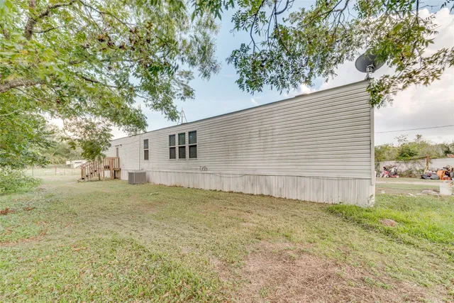 a view of a backyard with large trees