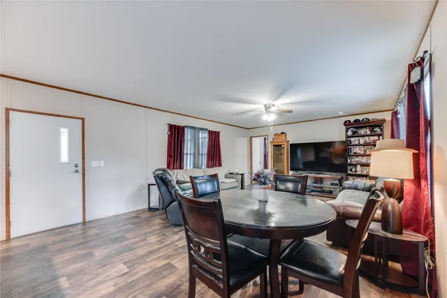a view of a dining room with furniture and wooden floor