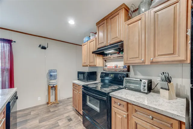 a kitchen with stainless steel appliances granite countertop a sink a stove a refrigerator and cabinets