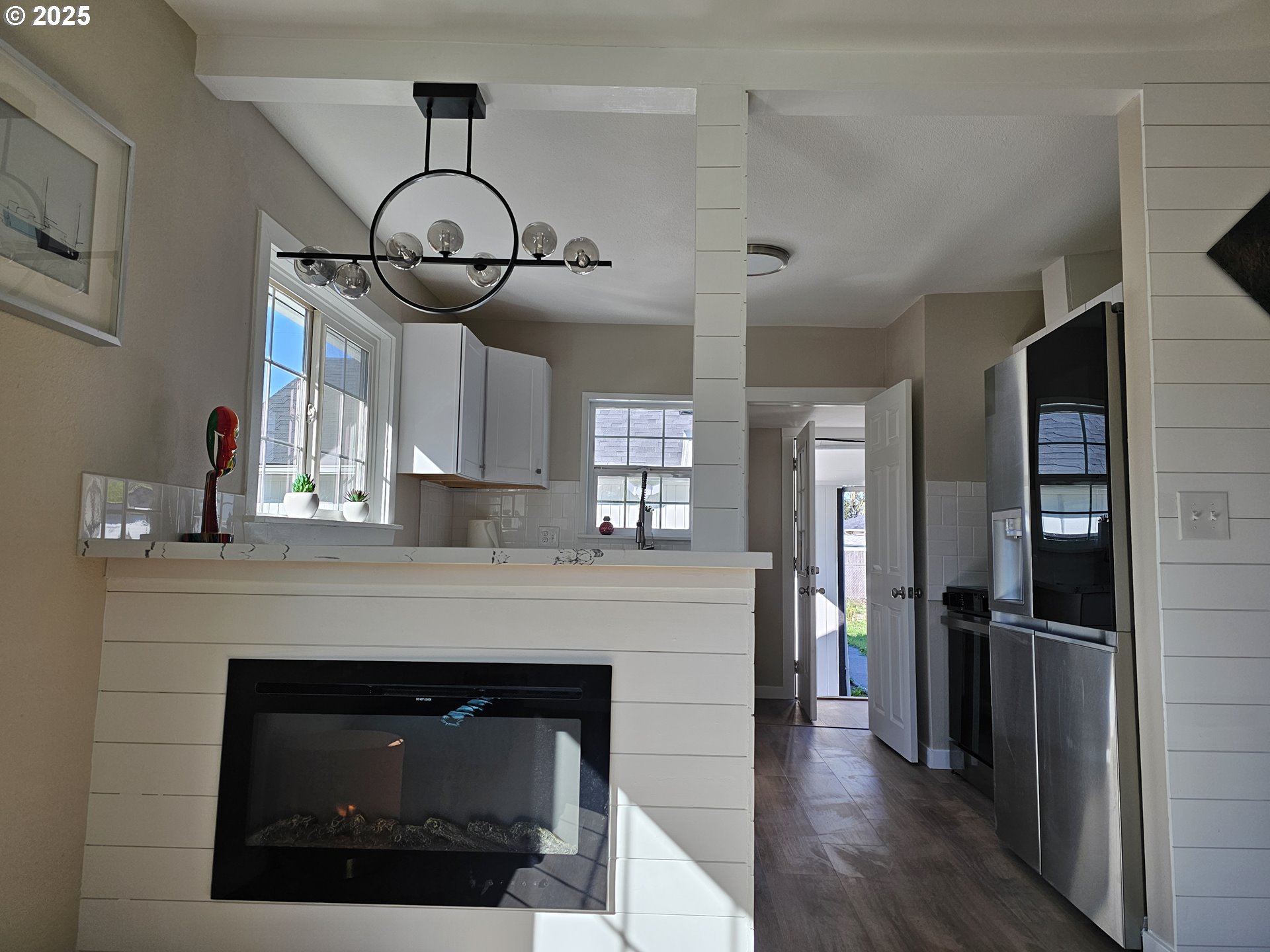 3128 Garfield Street Longview, WA 98632 - Photo 21 of 48 a kitchen with stainless steel appliances granite countertop a refrigerator a stove and a wooden floors