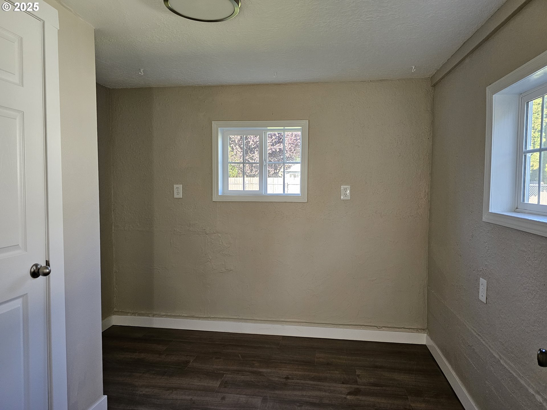 3128 Garfield Street Longview, WA 98632 - Photo 41 of 48 an empty room with wooden floor and windows
