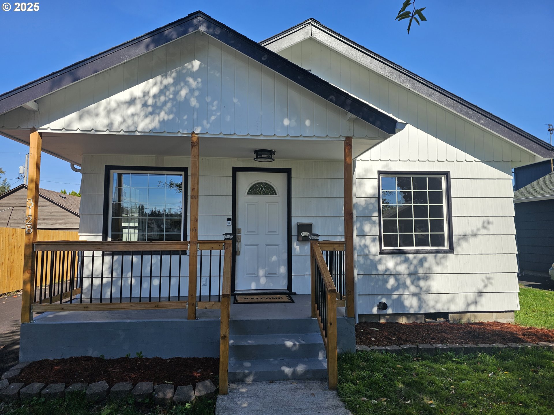 3128 Garfield Street Longview, WA 98632 - Photo 5 of 48 a front view of a house with glass windows and a yard