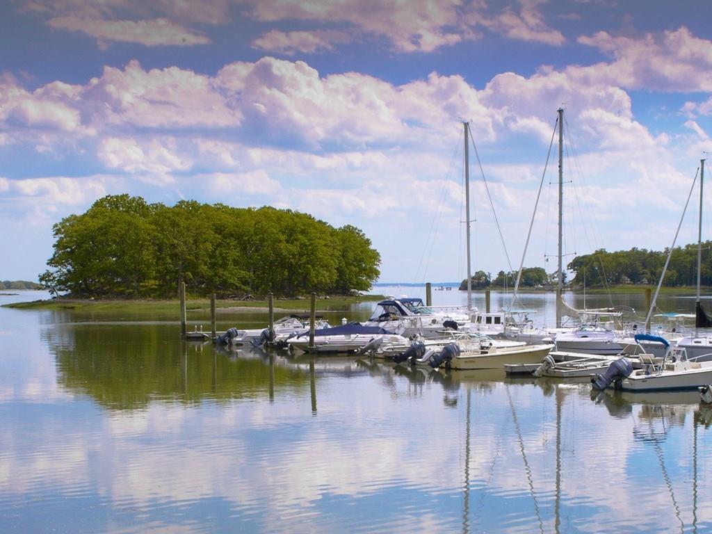a view of a lake with boats next to building