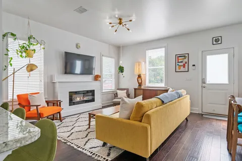 a living room with furniture and a fireplace